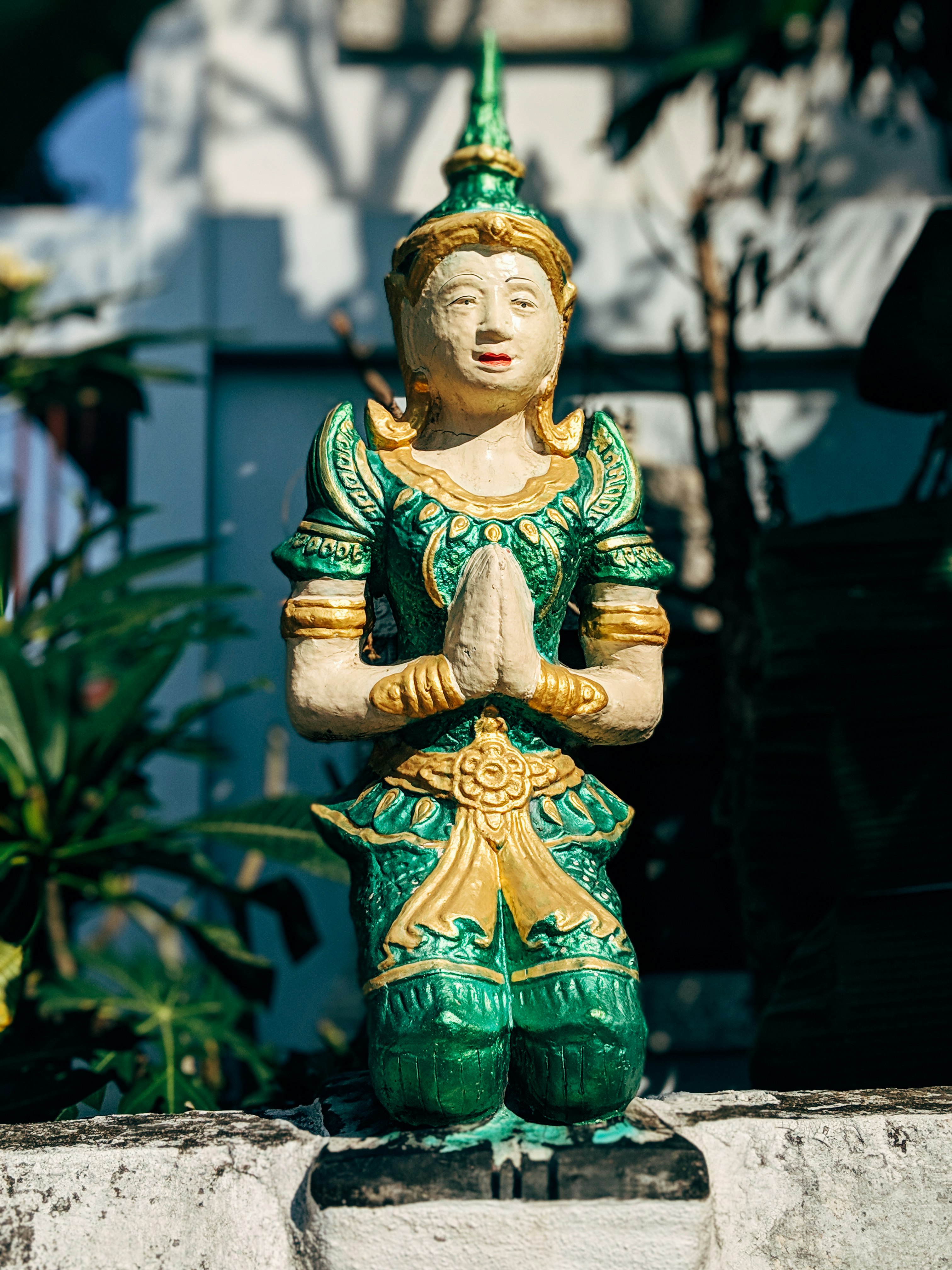 green and yellow ceramic buddha figurine